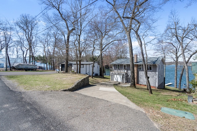 11672 Bradley Dr, Jerome, MI 49249 - view of front of home with driveway, a front yard, and an outdoor structure