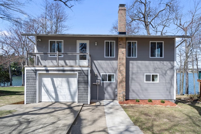 11672 Bradley Dr, Jerome, MI 49249 - view of front of house with an attached garage, a balcony, driveway, and a chimney