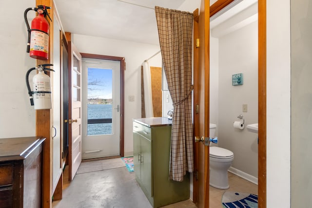 11672 Bradley Dr, Jerome, MI 49249 - bathroom with a water view, a shower with shower curtain, and toilet