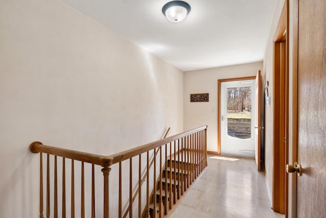 11672 Bradley Dr, Jerome, MI 49249 - hallway with baseboards, an upstairs landing, and light floors
