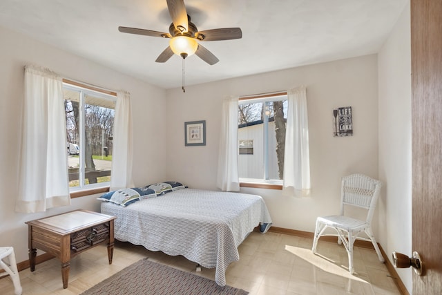 11672 Bradley Dr, Jerome, MI 49249 - bedroom with a ceiling fan, baseboards, and multiple windows