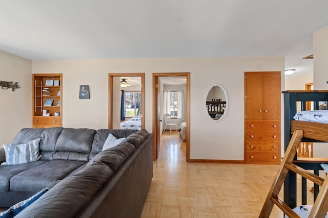 11672 Bradley Dr, Jerome, MI 49249 - living area featuring baseboards and a ceiling fan