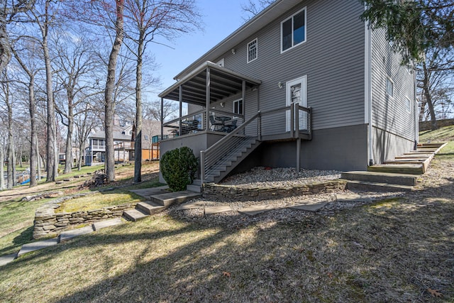 11672 Bradley Dr, Jerome, MI 49249 - rear view of house with stairs and a wooden deck