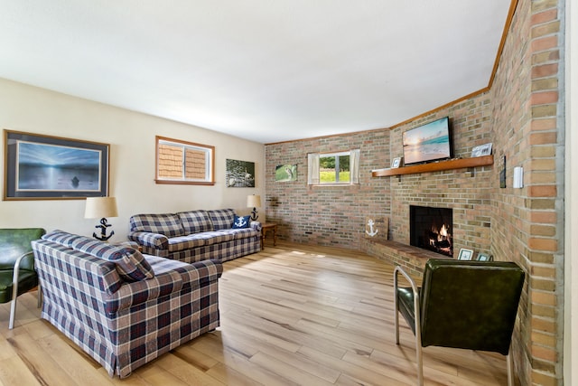 11672 Bradley Dr, Jerome, MI 49249 - living room featuring brick wall, a fireplace, and light wood-type flooring
