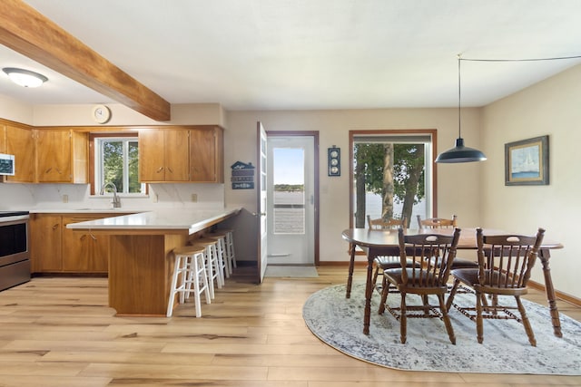 11672 Bradley Dr, Jerome, MI 49249 - dining area with light wood-type flooring and beam ceiling