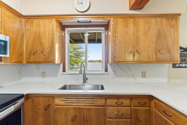 11672 Bradley Dr, Jerome, MI 49249 - kitchen featuring light countertops, brown cabinetry, and backsplash