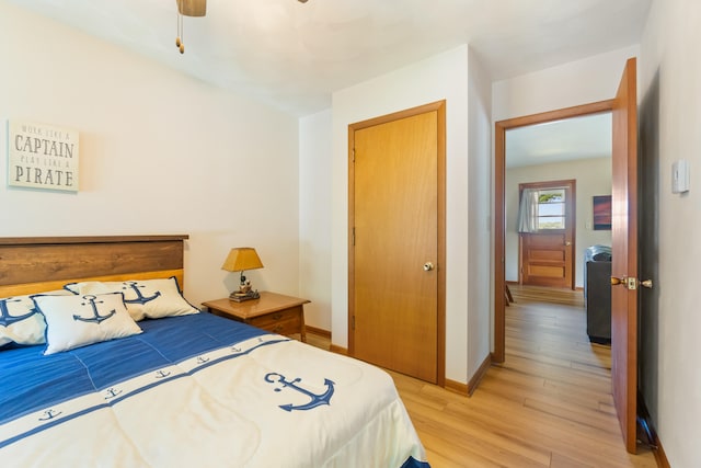 11672 Bradley Dr, Jerome, MI 49249 - bedroom with light wood finished floors, a closet, and ceiling fan