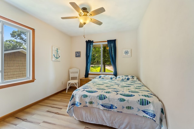 11672 Bradley Dr, Jerome, MI 49249 - bedroom with light wood-style floors and ceiling fan