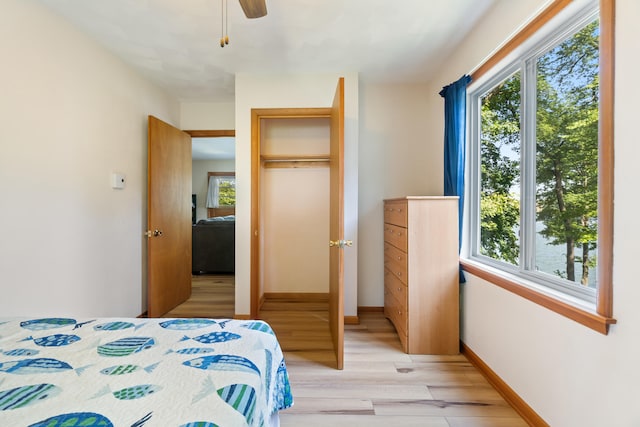 11672 Bradley Dr, Jerome, MI 49249 - bedroom with light wood-style flooring, multiple windows, and a ceiling fan