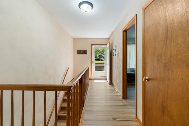 11672 Bradley Dr, Jerome, MI 49249 - hallway featuring an upstairs landing and light wood-style floors
