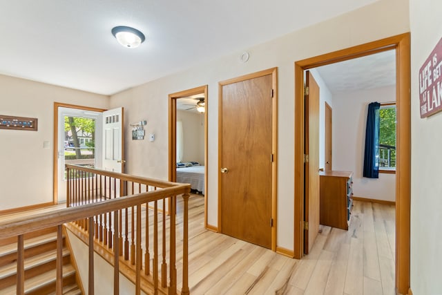 11672 Bradley Dr, Jerome, MI 49249 - hall with healthy amount of natural light, light wood-type flooring, and an upstairs landing
