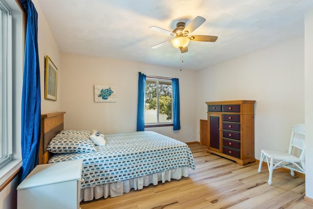 11672 Bradley Dr, Jerome, MI 49249 - bedroom with light wood-style floors and ceiling fan