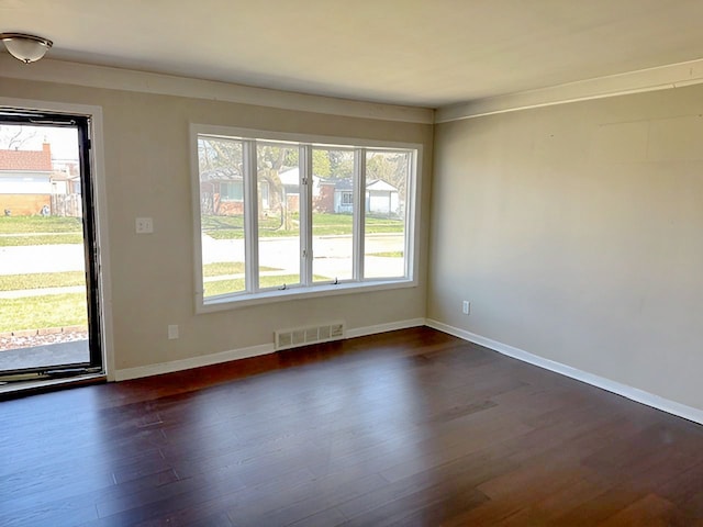 22169 Fairfax St, Taylor, MI 48180 - spare room with baseboards, dark wood-style flooring, and visible vents