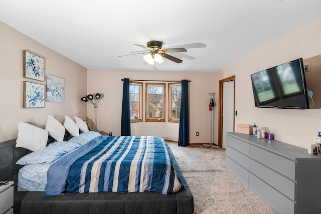 bedroom with light carpet, a ceiling fan, and baseboards