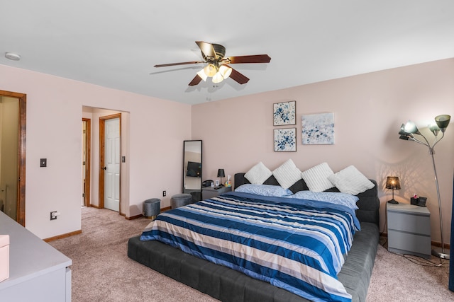 bedroom with light carpet, a ceiling fan, and baseboards