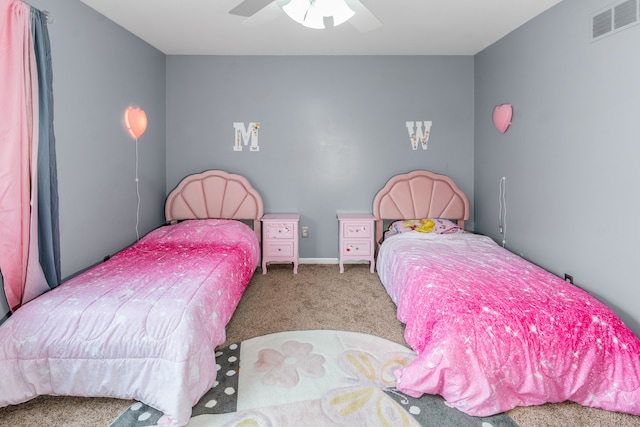 carpeted bedroom featuring visible vents and ceiling fan