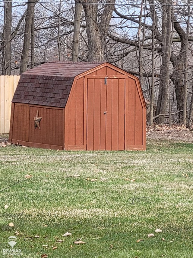 view of shed featuring fence