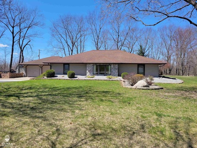 ranch-style home with an attached garage, concrete driveway, and a front lawn