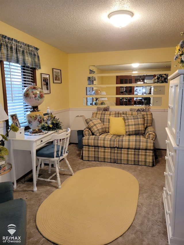 carpeted living room featuring a textured ceiling