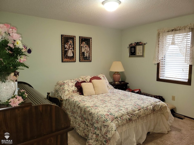 carpeted bedroom featuring a textured ceiling
