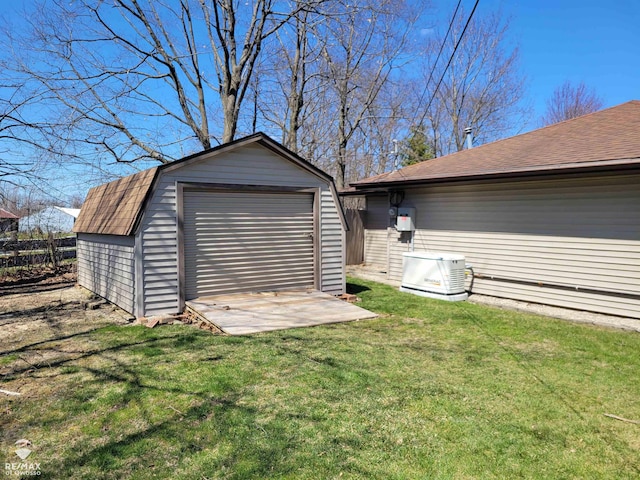 garage featuring a storage unit and fence