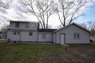 rear view of property with a yard