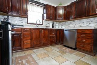 kitchen with stainless steel appliances, light countertops, and backsplash