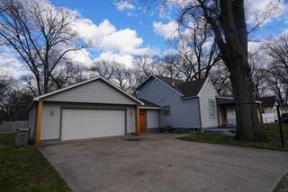 view of front of home with aphalt driveway and a garage