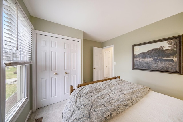 bedroom featuring a closet, visible vents, and carpet floors