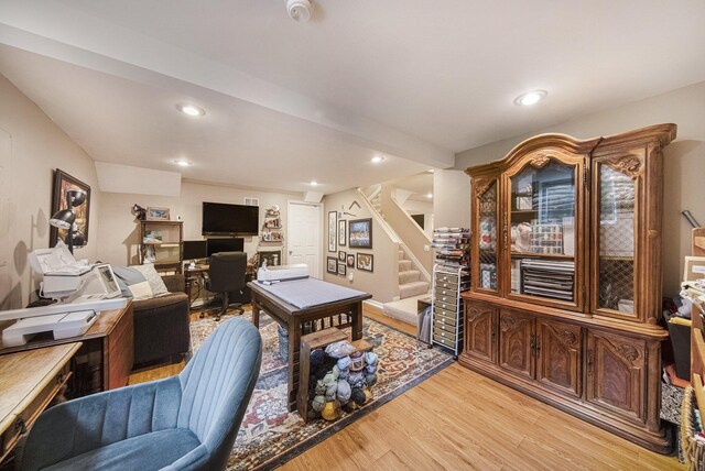 living area with light wood finished floors, recessed lighting, and stairs