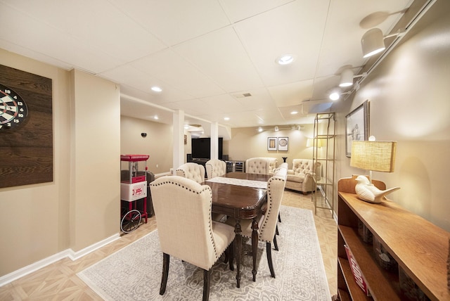 dining area featuring baseboards, recessed lighting, and a drop ceiling