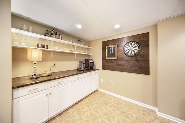 bar with light floors, baseboards, and recessed lighting