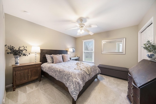 bedroom with ceiling fan and light carpet