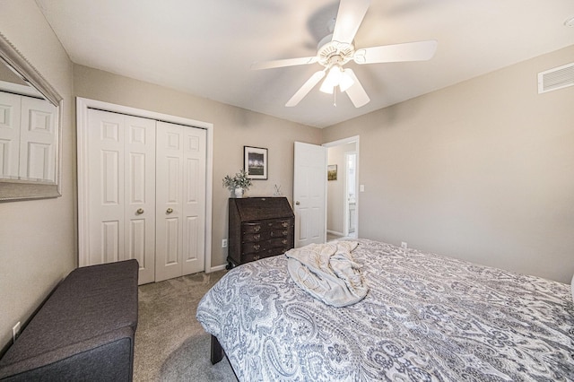 carpeted bedroom featuring visible vents, a closet, and a ceiling fan