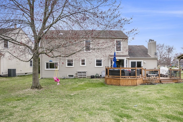 back of house featuring a yard, a chimney, a deck, and central air condition unit