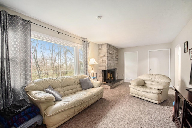 living area with a fireplace and carpet