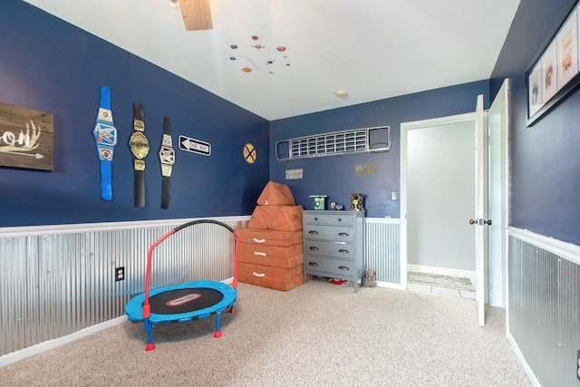 bedroom with carpet flooring and wainscoting