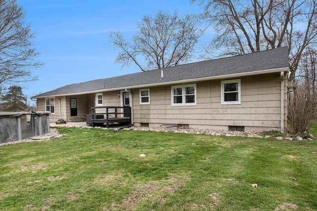 rear view of house with a yard and a wooden deck