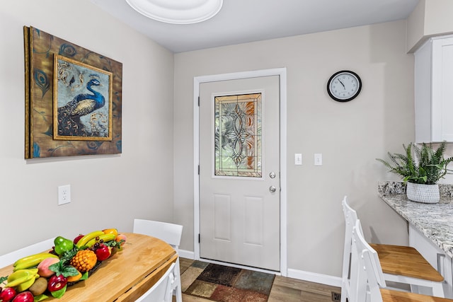 foyer featuring baseboards