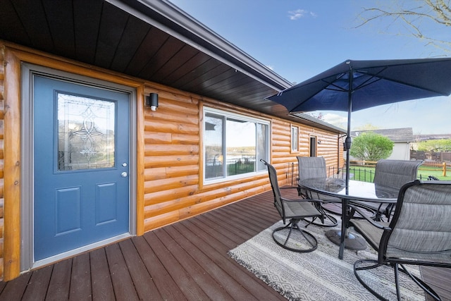 wooden terrace featuring outdoor dining area