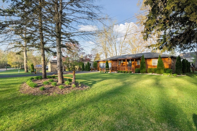 view of yard featuring a porch and driveway