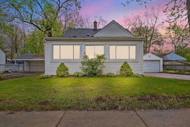 21160 Inkster Rd, Southfield, MI 48033 - view of front of home with fence, an outdoor structure, a chimney, and a lawn
