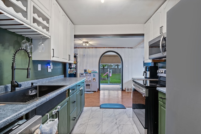 21160 Inkster Rd, Southfield, MI 48033 - kitchen featuring white cabinetry, appliances with stainless steel finishes, and a sink