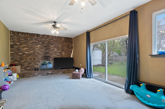 21160 Inkster Rd, Southfield, MI 48033 - unfurnished living room with a healthy amount of sunlight, carpet floors, ceiling fan, and a fireplace