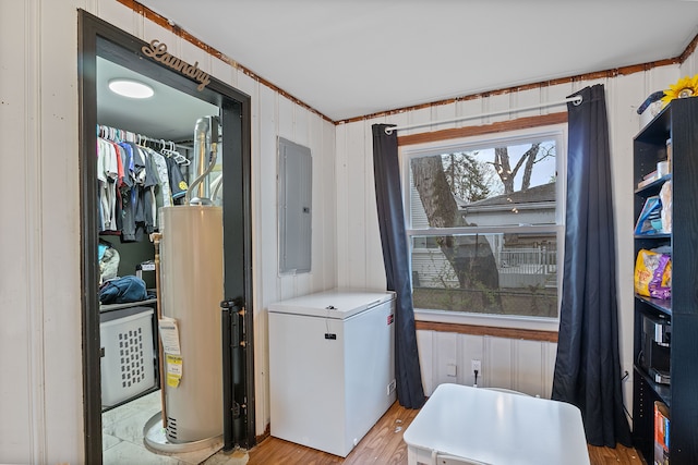 21160 Inkster Rd, Southfield, MI 48033 - clothes washing area with laundry area, light wood finished floors, electric panel, and gas water heater