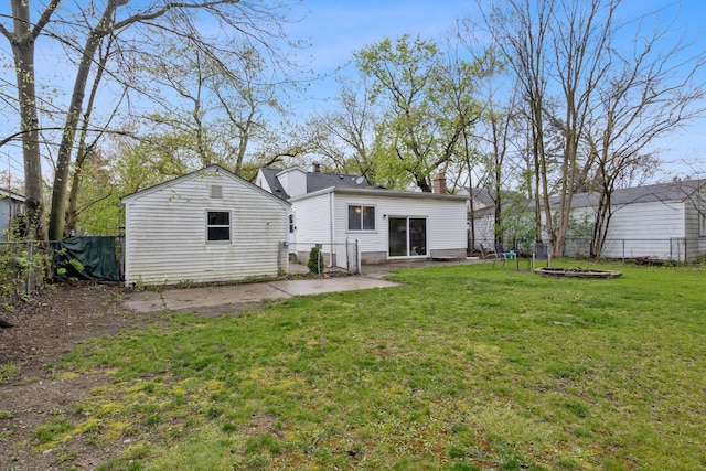 21160 Inkster Rd, Southfield, MI 48033 - rear view of house with a fenced backyard, a chimney, a yard, and a patio area