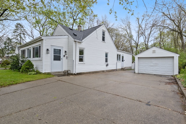 21160 Inkster Rd, Southfield, MI 48033 - view of side of property with an outdoor structure, a garage, a chimney, a shingled roof, and entry steps