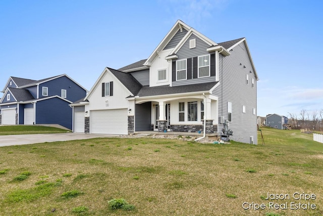 view of front of home featuring board and batten siding, a porch, stone siding, a front lawn, and driveway