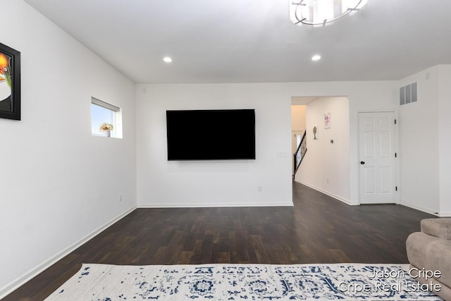 unfurnished living room featuring baseboards, wood finished floors, visible vents, and recessed lighting