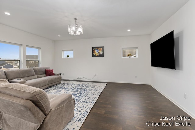 living area featuring an inviting chandelier, baseboards, dark wood finished floors, and recessed lighting